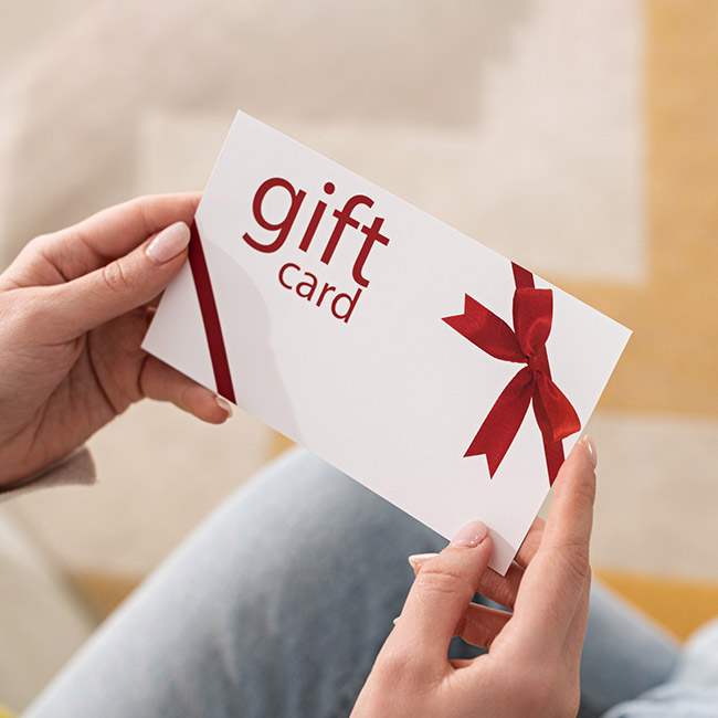 Close up of a woman's hands holding a gift card